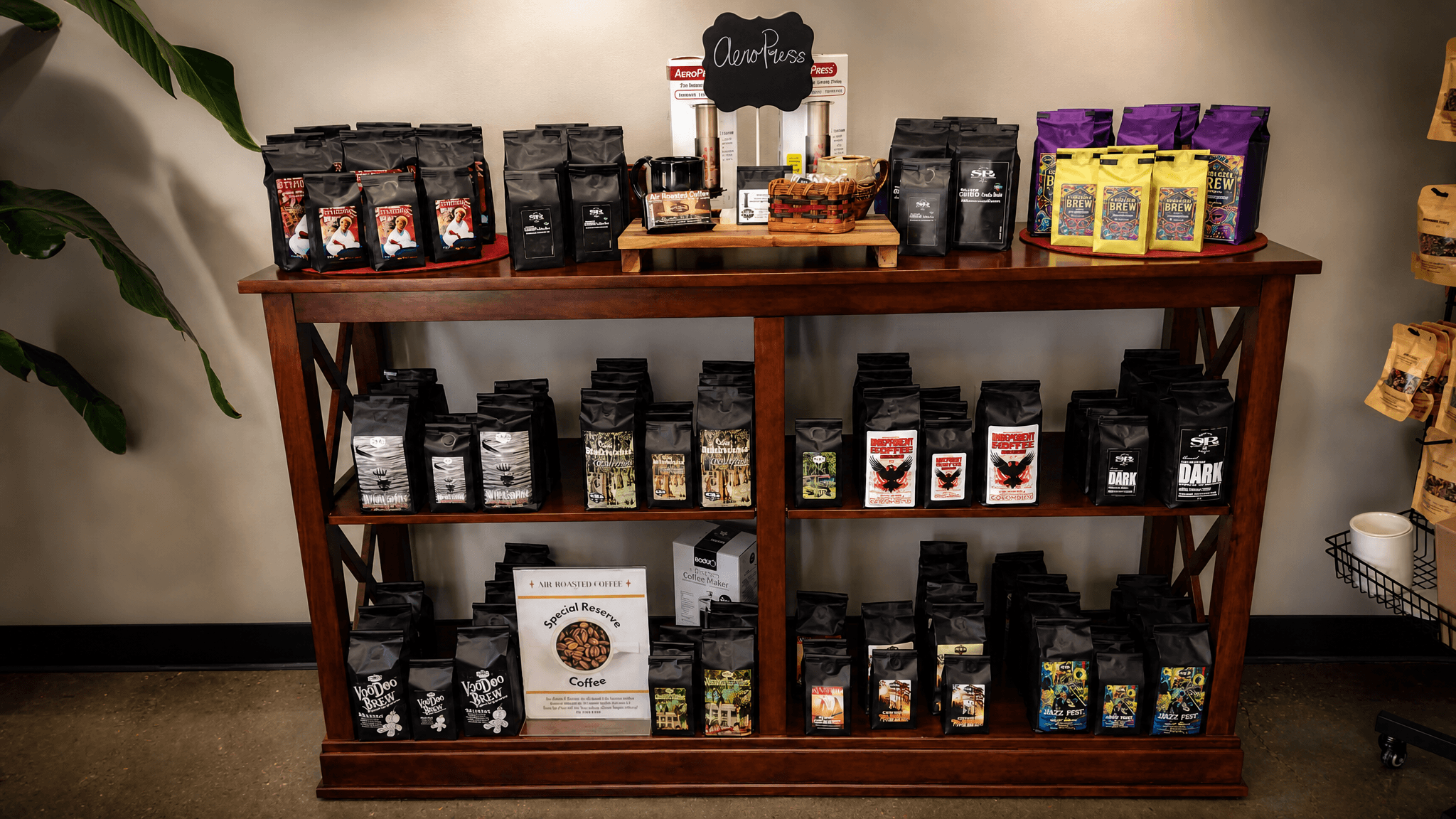 A retail shelf display stocked with Special Reserve Coffee bags and brewing gear